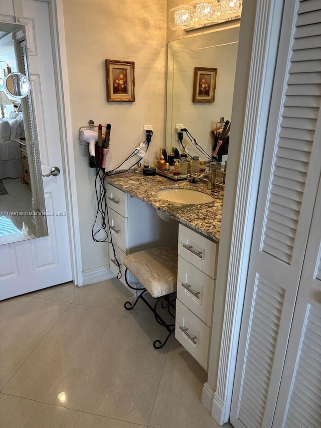 500 Three Islands Blvd Unit 313, Hallandale Beach, FL 33009 - ensuite bathroom featuring tile patterned flooring, vanity, and baseboards