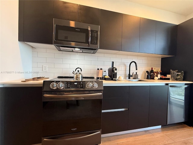 398 NE 5th St Unit 2805, Miami, FL 33132 - kitchen with appliances with stainless steel finishes, a sink, light countertops, tasteful backsplash, and a warming drawer