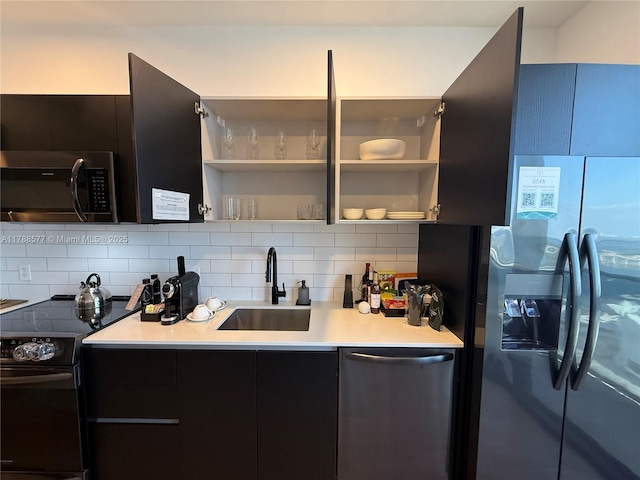 398 NE 5th St Unit 2805, Miami, FL 33132 - kitchen featuring appliances with stainless steel finishes, a sink, open shelves, and backsplash