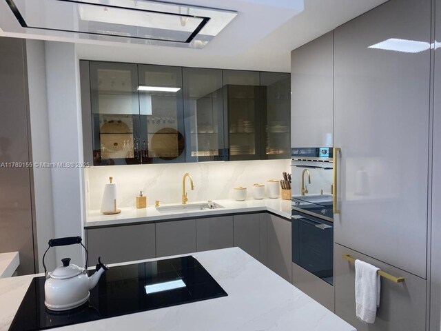 1450 Brickell Bay Dr Unit 1709, Miami, FL 33131 - kitchen with modern cabinets, white refrigerator, a sink, and gray cabinets