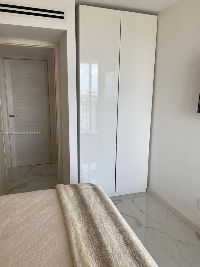1450 Brickell Bay Dr Unit 1709, Miami, FL 33131 - bedroom featuring marble finish floor and baseboards