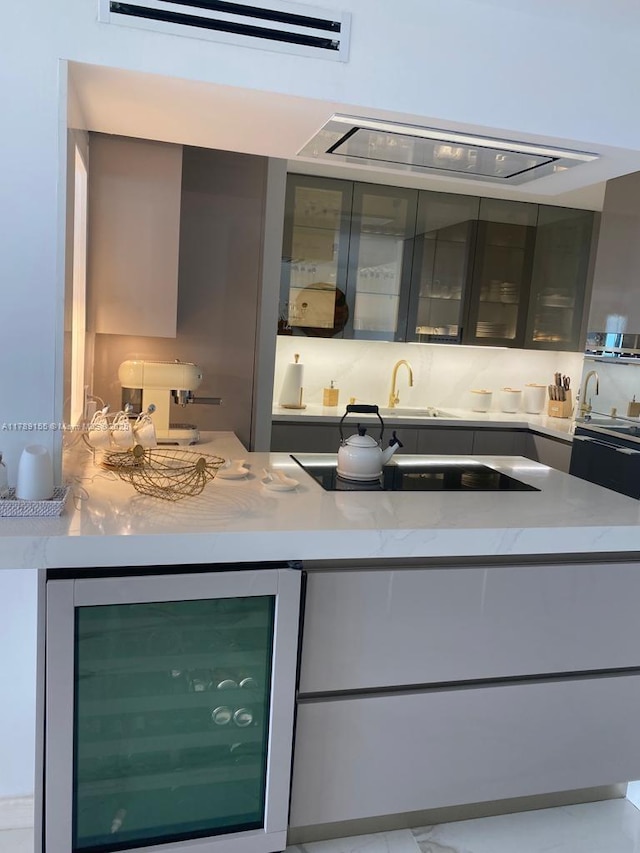 1450 Brickell Bay Dr Unit 1709, Miami, FL 33131 - bar featuring beverage cooler, extractor fan, a wall unit AC, a sink, and black electric stovetop
