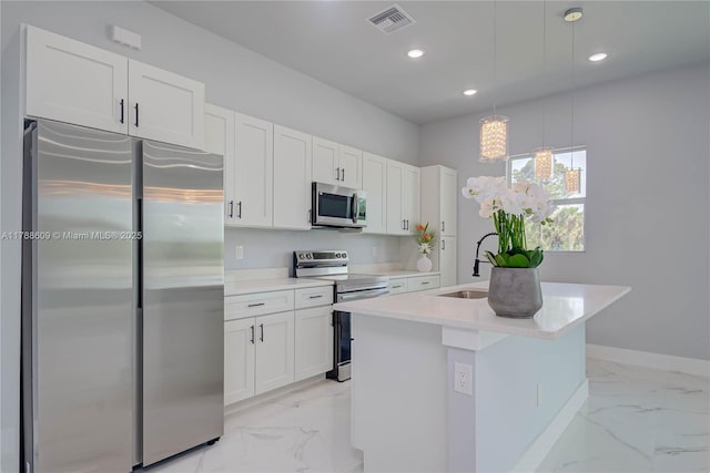 kitchen featuring marble finish floor, visible vents, a sink, a center island with sink, and appliances with stainless steel finishes