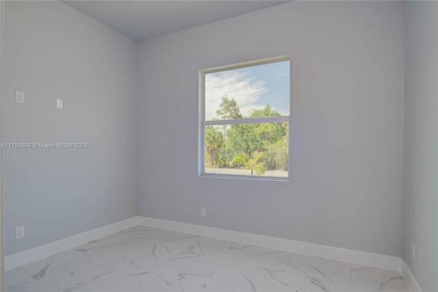 unfurnished room with baseboards and marble finish floor