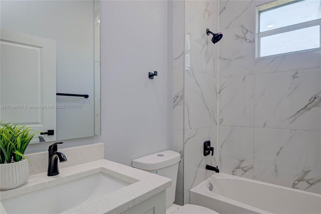 bathroom with toilet, shower / bathtub combination, and vanity