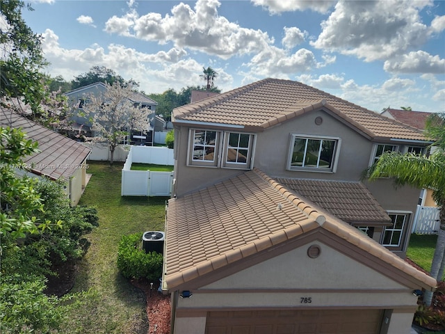 785 Falling Water Rd, Weston, FL 33326 - rear view of house featuring a gate, a fenced backyard, stucco siding, a tile roof, and a garage