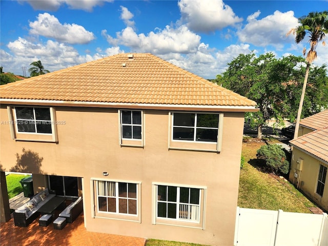 785 Falling Water Rd, Weston, FL 33326 - rear view of house featuring fence, a tile roof, and stucco siding