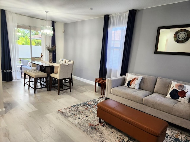 785 Falling Water Rd, Weston, FL 33326 - living area with wood finished floors, baseboards, and a notable chandelier