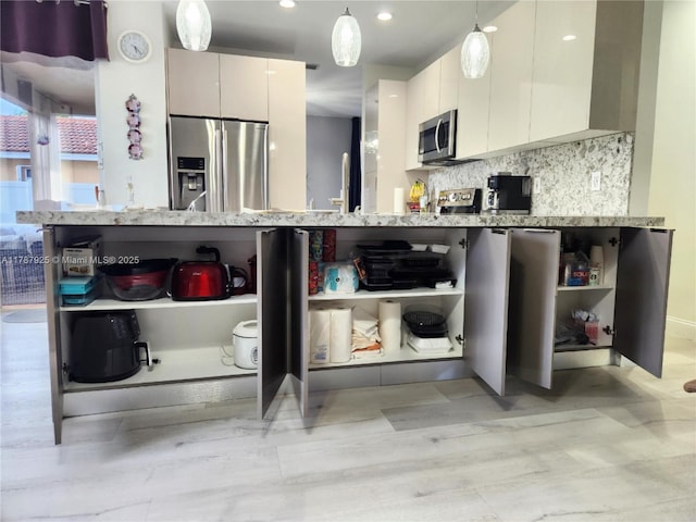 785 Falling Water Rd, Weston, FL 33326 - kitchen featuring open shelves, stainless steel appliances, light stone countertops, and modern cabinets