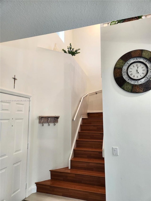 785 Falling Water Rd, Weston, FL 33326 - stairway featuring wood finished floors and a textured ceiling