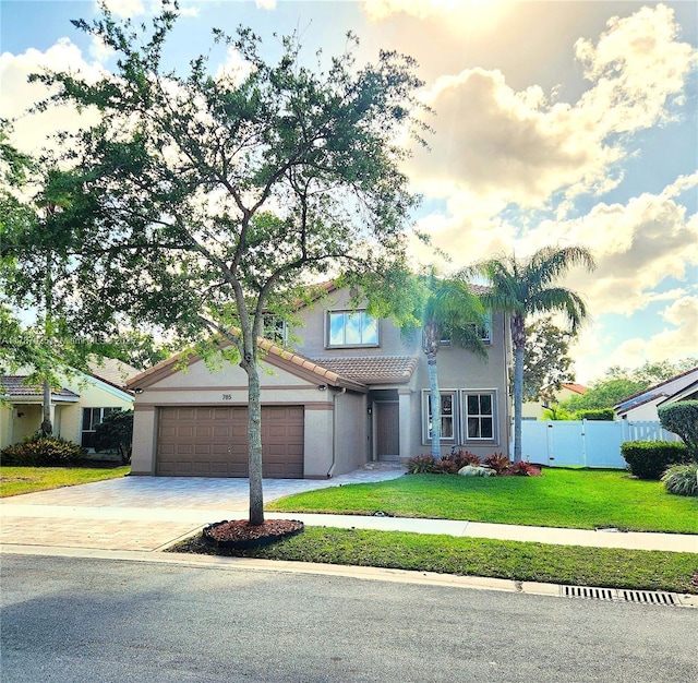 785 Falling Water Rd, Weston, FL 33326 - traditional-style home with fence, a tiled roof, a front lawn, stucco siding, and driveway