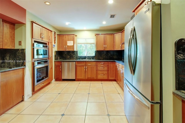 14875 SW 238th St, Homestead, FL 33032 - kitchen with appliances with stainless steel finishes, a sink, tasteful backsplash, dark countertops, and recessed lighting