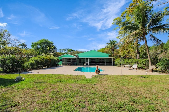 14875 SW 238th St, Homestead, FL 33032 - swimming pool featuring a lawn, a patio area, and a sunroom