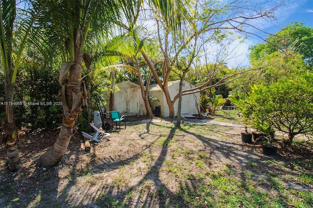 14875 SW 238th St, Homestead, FL 33032 - view of yard with a storage unit and an outdoor structure