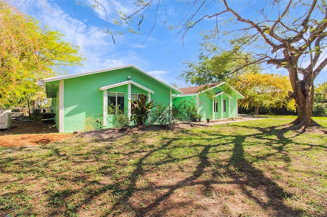 14875 SW 238th St, Homestead, FL 33032 - back of house featuring stucco siding and a yard