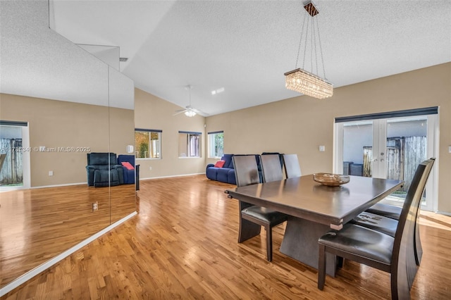 dining area featuring french doors, a textured ceiling, and light wood-style floors