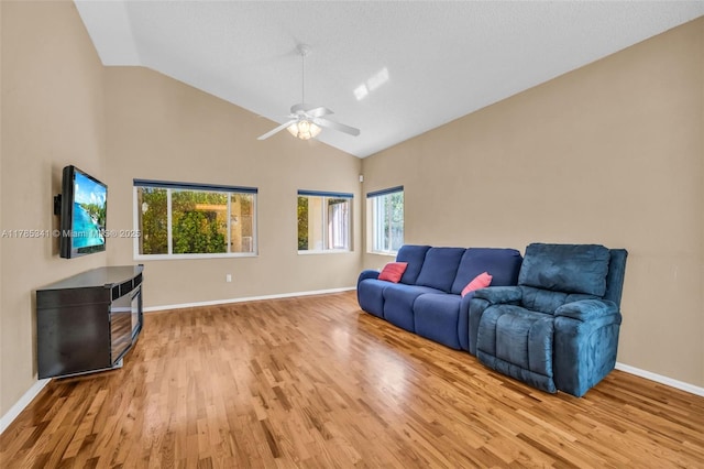 living room featuring baseboards, wood finished floors, and ceiling fan