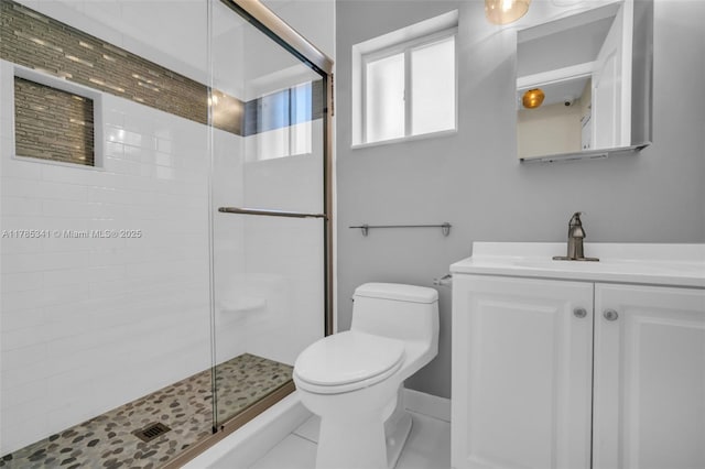 full bathroom with toilet, vanity, and a stall shower