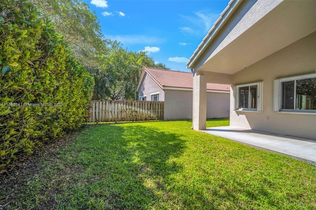 view of yard featuring a patio area and fence