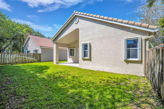 back of property featuring a patio area, a lawn, a fenced backyard, and stucco siding