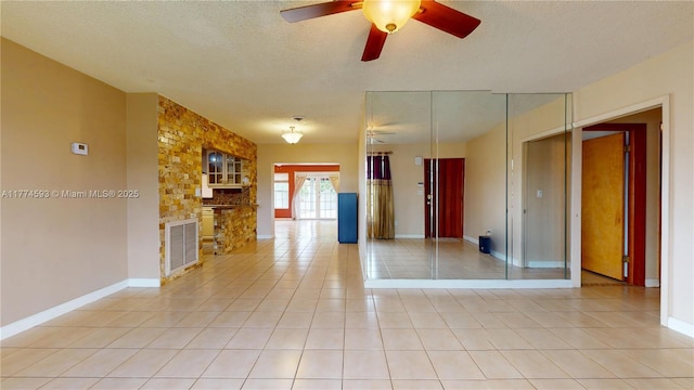 6051 SW 110th Ave, Miami, FL 33173 - empty room with baseboards, a ceiling fan, a textured ceiling, and light tile patterned floors