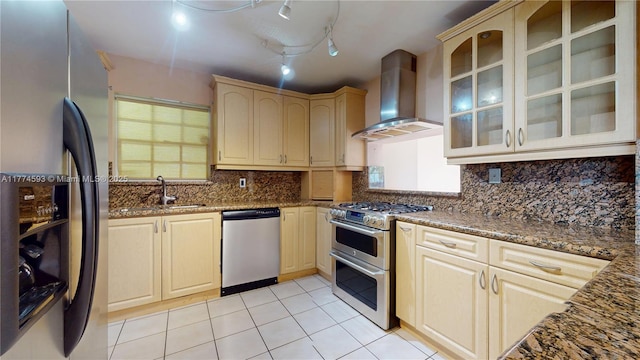 6051 SW 110th Ave, Miami, FL 33173 - kitchen featuring wall chimney range hood, appliances with stainless steel finishes, light tile patterned floors, a sink, and glass insert cabinets