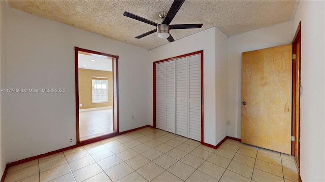6051 SW 110th Ave, Miami, FL 33173 - unfurnished bedroom with light tile patterned floors, baseboards, a closet, and a textured ceiling