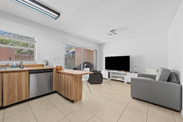 1341 NW 123rd Ter Unit 1341, Pembroke Pines, FL 33026 - kitchen with a peninsula, stainless steel dishwasher, a sink, open floor plan, and light countertops