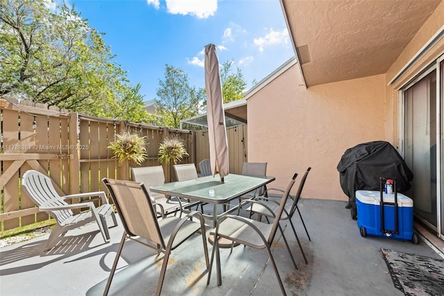 1341 NW 123rd Ter Unit 1341, Pembroke Pines, FL 33026 - view of patio featuring outdoor dining area, fence, and a grill