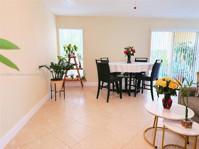 805 Riverside Dr Unit 1111, Coral Springs, FL 33071 - dining space featuring baseboards, a healthy amount of sunlight, and light tile patterned flooring