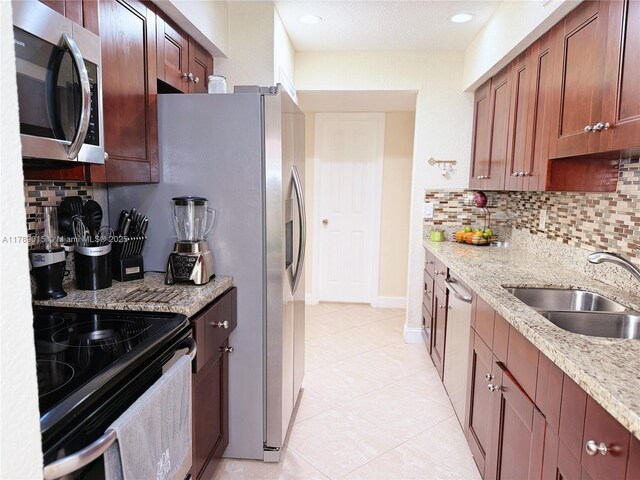 805 Riverside Dr Unit 1111, Coral Springs, FL 33071 - kitchen with backsplash, light tile patterned flooring, stainless steel appliances, and a sink