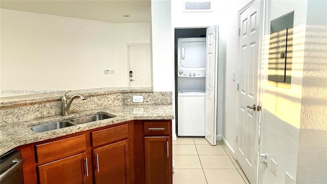 10620 NW 88th St Unit 205, Doral, FL 33178 - clothes washing area with a sink, light tile patterned floors, laundry area, stacked washer / drying machine, and visible vents