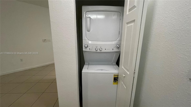 10620 NW 88th St Unit 205, Doral, FL 33178 - laundry area featuring a textured wall, tile patterned flooring, stacked washer and dryer, and laundry area