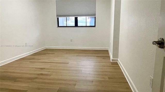 10620 NW 88th St Unit 205, Doral, FL 33178 - unfurnished room with baseboards and wood finished floors