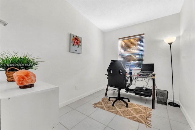 office with baseboards, light tile patterned flooring, and lofted ceiling