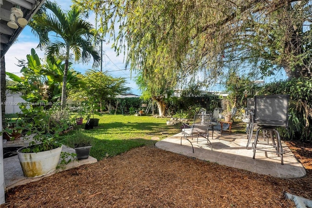 view of yard featuring fence and a patio area