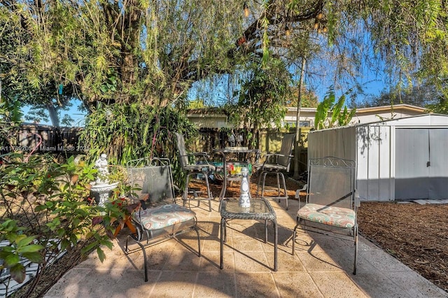 view of patio featuring a fenced backyard, an outdoor structure, and a shed