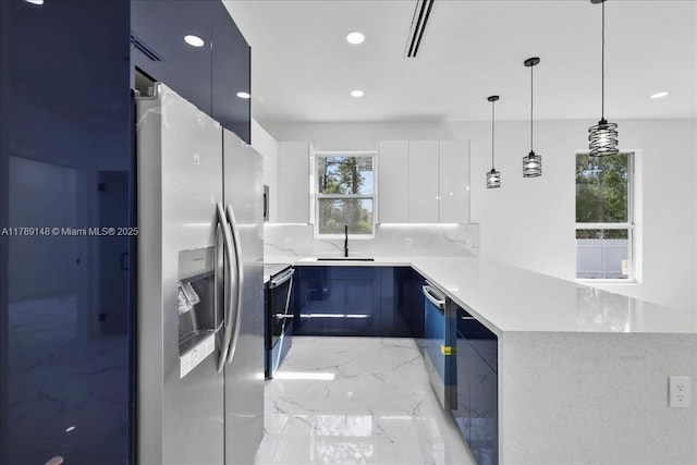 924 Berg St E, Lehigh Acres, FL 33974 - kitchen featuring a sink, a peninsula, modern cabinets, and appliances with stainless steel finishes
