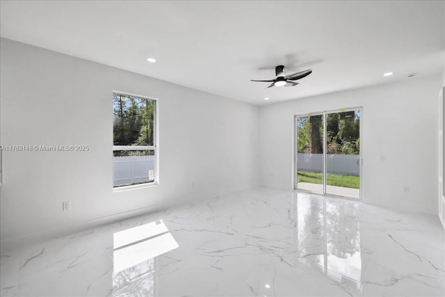 924 Berg St E, Lehigh Acres, FL 33974 - spare room with a healthy amount of sunlight, ceiling fan, recessed lighting, and marble finish floor