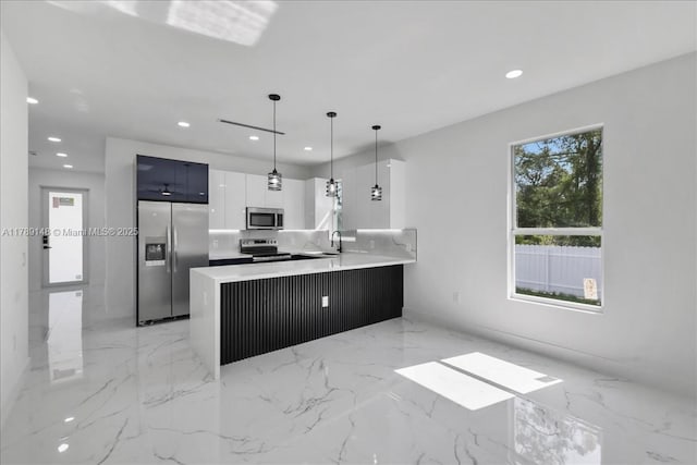 924 Berg St E, Lehigh Acres, FL 33974 - kitchen featuring recessed lighting, appliances with stainless steel finishes, pendant lighting, a peninsula, and modern cabinets