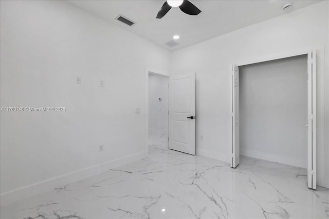 924 Berg St E, Lehigh Acres, FL 33974 - unfurnished bedroom with marble finish floor, visible vents, ceiling fan, and baseboards