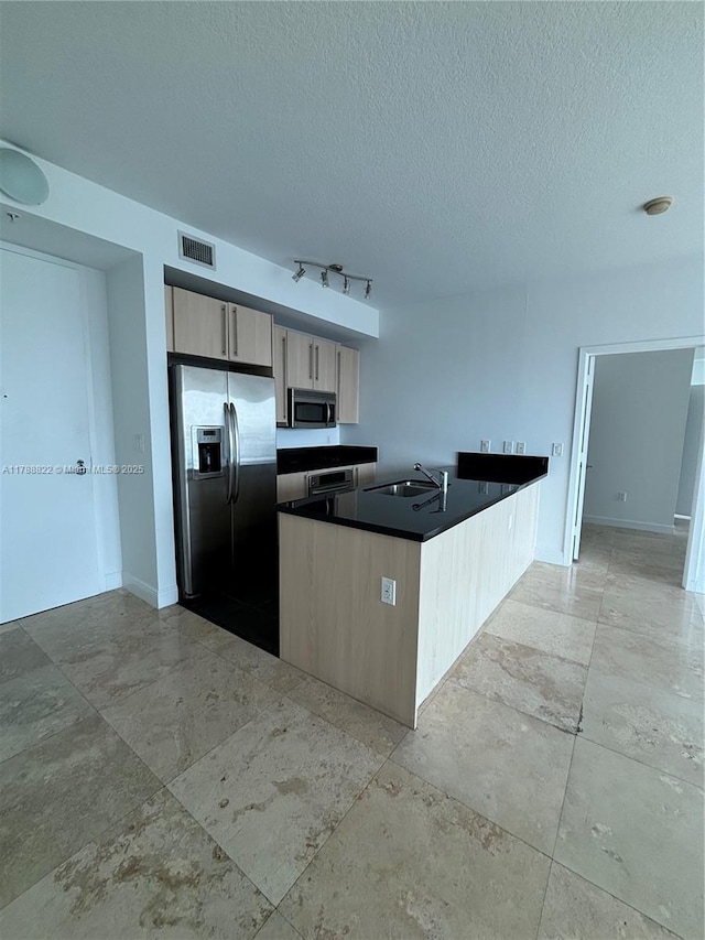 79 SW 12th St Unit 2703-S, Miami, FL 33130 - kitchen featuring dark countertops, visible vents, a sink, a textured ceiling, and appliances with stainless steel finishes