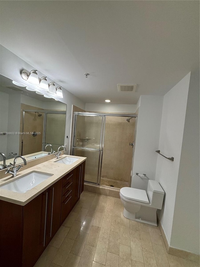 79 SW 12th St Unit 2703-S, Miami, FL 33130 - bathroom with visible vents, toilet, a stall shower, and a sink