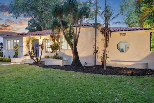 558 NE 94th St, Miami Shores, FL 33138 - exterior space featuring a lawn, a tile roof, and stucco siding