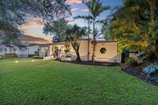 558 NE 94th St, Miami Shores, FL 33138 - exterior space with stucco siding, fence, a yard, and a tiled roof