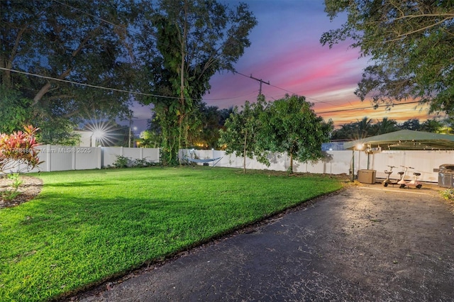 558 NE 94th St, Miami Shores, FL 33138 - yard at dusk featuring a fenced backyard