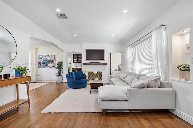 558 NE 94th St, Miami Shores, FL 33138 - living room with recessed lighting, lofted ceiling, wood finished floors, visible vents, and arched walkways