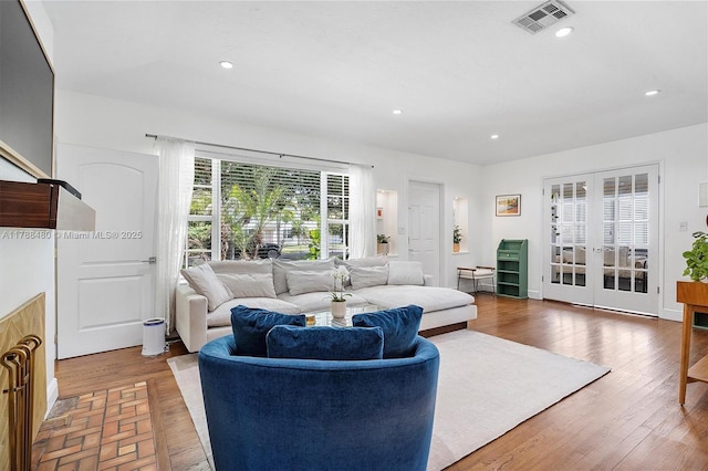 558 NE 94th St, Miami Shores, FL 33138 - living area featuring recessed lighting, wood finished floors, visible vents, and french doors
