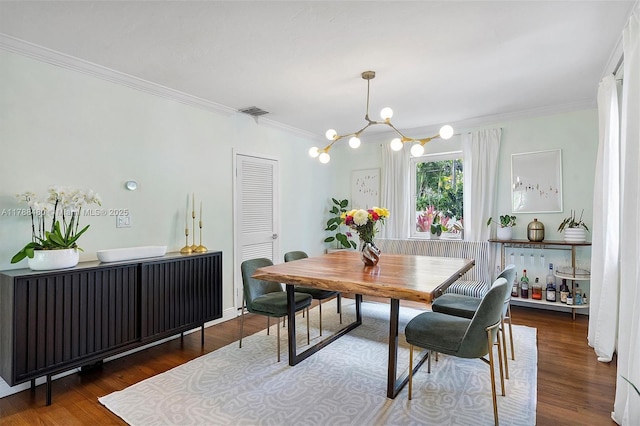 558 NE 94th St, Miami Shores, FL 33138 - dining area featuring ornamental molding, wood finished floors, a chandelier, and visible vents