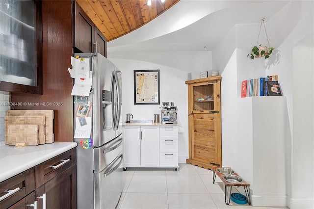 558 NE 94th St, Miami Shores, FL 33138 - kitchen featuring light countertops, stainless steel fridge, dark brown cabinets, and light tile patterned flooring